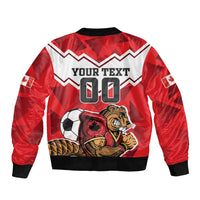 Red satin bomber jacket with black ribbed cuffs and large beaver soccer graphic