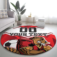 Red round football rug with soccer ball, beaver mascot, and “YOUR TEXT” across center