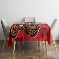Red football tablecloth with beaver mascot print draped over square dining table