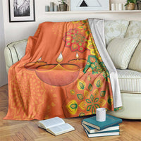 Saffron Diwali blanket on sofa with diya rangoli mandala pattern and leaf motifs