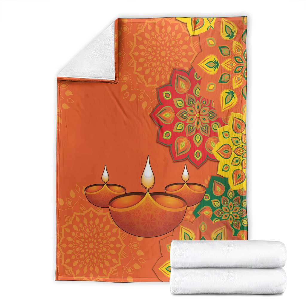 Saffron Diwali blanket with rangoli mandala and diya lamp print, multicolor border