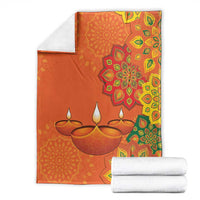 Saffron Diwali blanket with rangoli mandala and diya lamp print, multicolor border