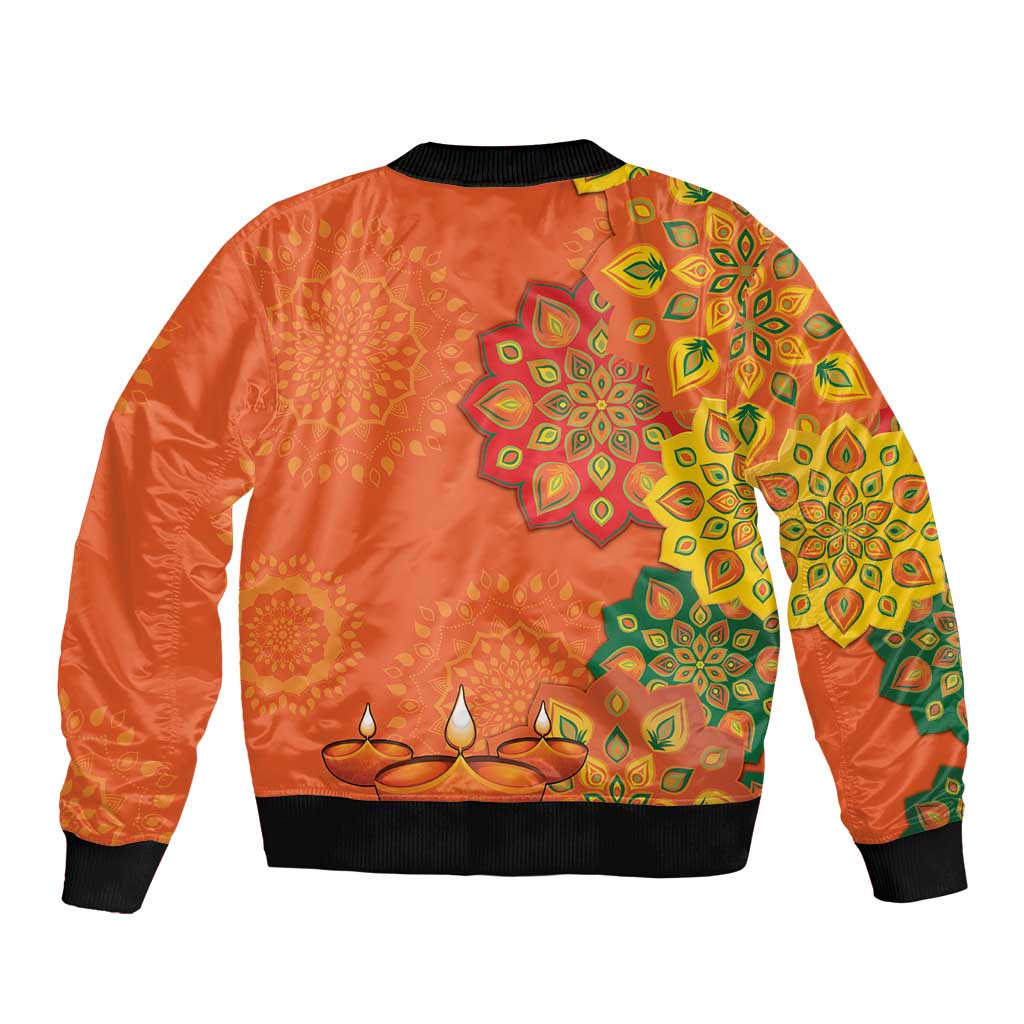 Orange unisex bomber jacket with rangoli-style floral patterns on back, ribbed hem