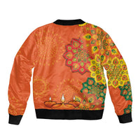Orange unisex bomber jacket with rangoli-style floral patterns on back, ribbed hem