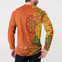 Orange button sweatshirt with green and yellow rangoli mandala and diya candles