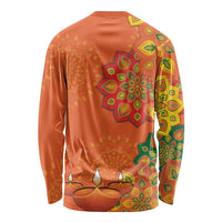 Unisex long-sleeve shirt in orange with large circular rangoli and leaf patterns