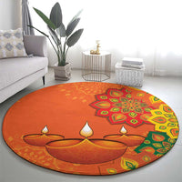 Round orange carpet with colorful rangoli-style floral and diya motif