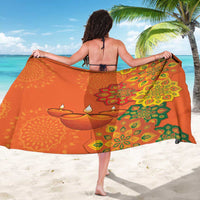 Orange sarong with green and yellow rangoli floral pattern, wide drape