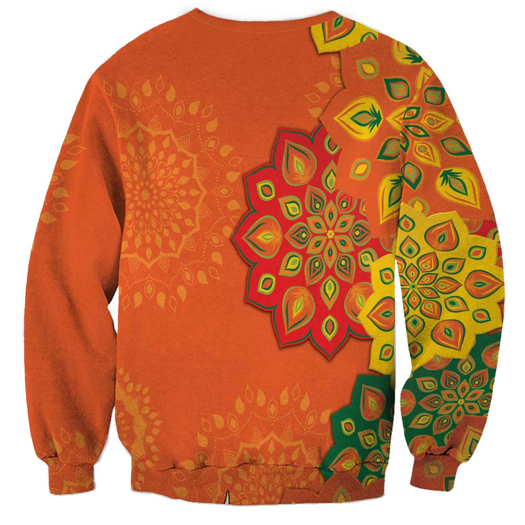Unisex orange sweatshirt with green and yellow mandala rangoli pattern on chest