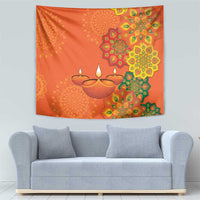 Saffron orange rangoli tapestry featuring multiple diyas and circular mandala design