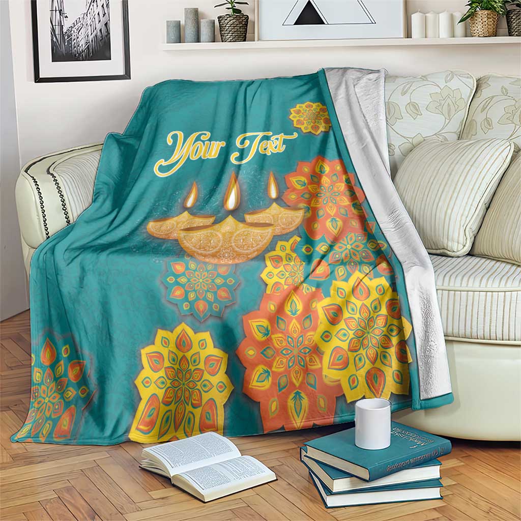 Personalized Diwali blanket in teal with gold “Your Text” and diya mandala designs