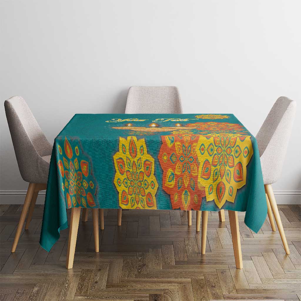 Teal tablecloth with yellow mandala pattern and small diya icons at table center