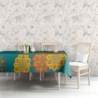 Teal tablecloth with colorful diya and mandala motifs on a dining table