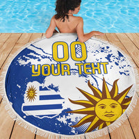Round beach blanket with blue and white Uruguay flag graphic, fringe edge, “00 YOUR TEXT”