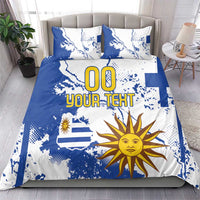 Blue and white bedding set with Uruguay map, sun graphic, and 'YOUR TEXT' print