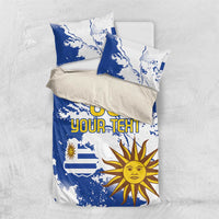 Blue and white bedding set with Uruguay map and sun graphic, two matching pillowcases