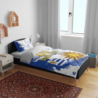 Blue and white bedding set with Uruguay flag map, sun artwork, and 'YOUR TEXT' print