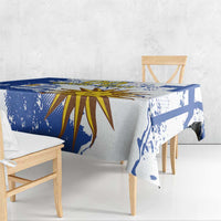 Blue and white tablecloth draped on table, featuring sunburst and blue splatter print