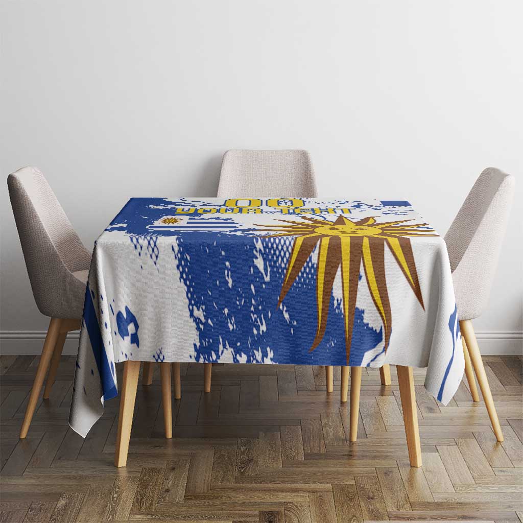 Blue and white tablecloth featuring a central sunburst and blue paint-splatter accents