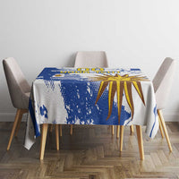 Blue and white tablecloth featuring a central sunburst and blue paint-splatter accents