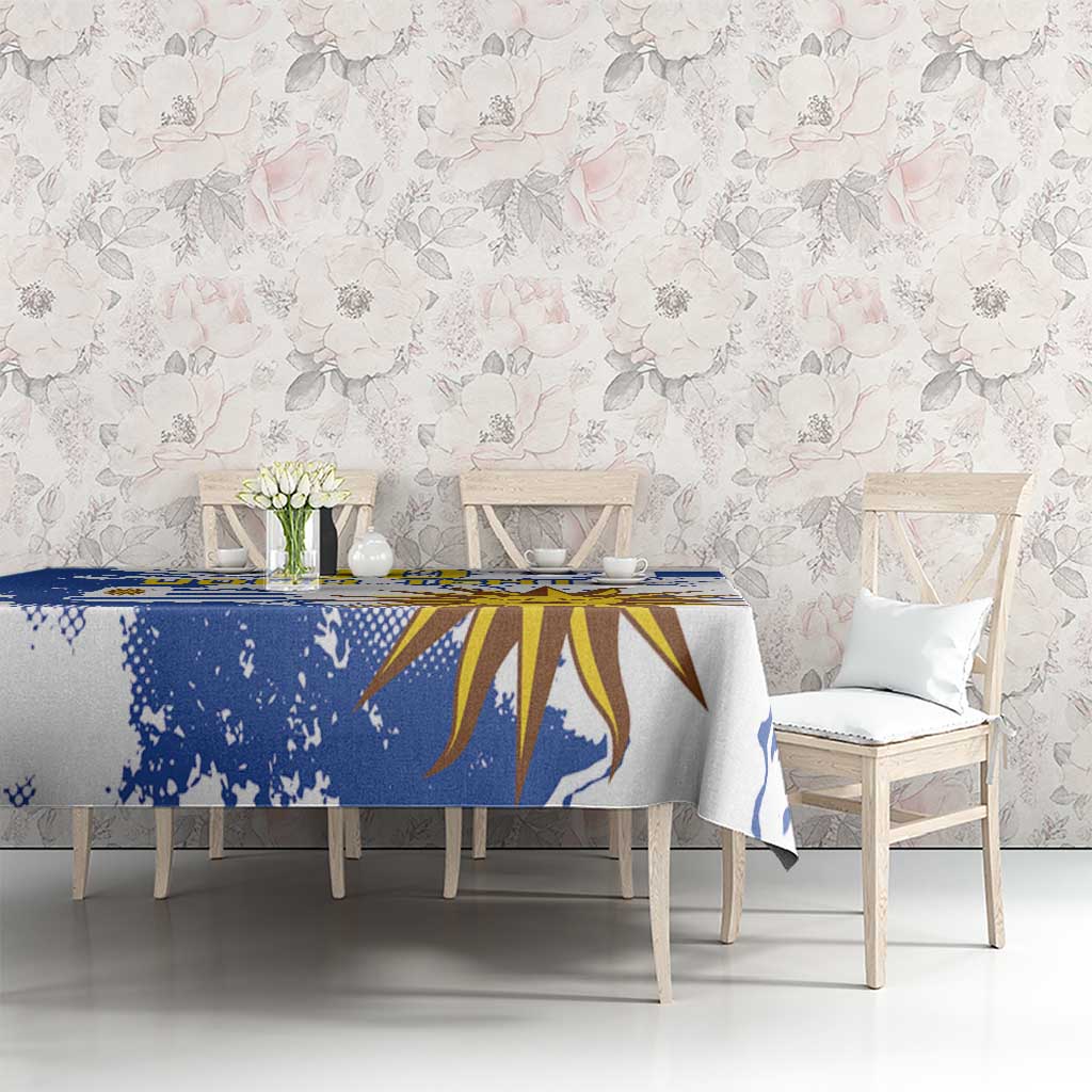 Blue and white tablecloth with sunburst design and distressed paint-splatter pattern