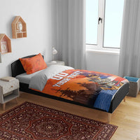 Orange camo bedding set on bed with two pillows, ship silhouettes and anchor badge