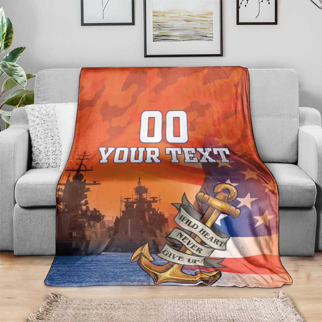 Orange custom US Navy veteran blanket on gray sofa, anchor and stars with custom text