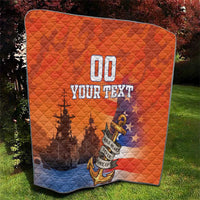 Orange and blue quilt outdoors, quilted diamonds with anchor emblem and “YOUR TEXT”