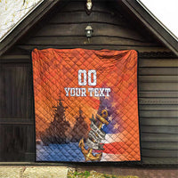 Orange and blue quilt with diamond stitching, anchor emblem and “YOUR TEXT” print