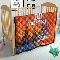 Orange and blue quilt on a toddler bed, diamond quilting with anchor graphic and “YOUR TEXT”