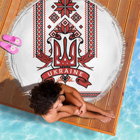 Round white beach blanket with red and black Ukraine trident folk pattern and tassel fringe