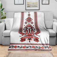 White couch throw blanket with red trident crest and folk motif panel border and flowers