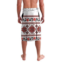 White folk-print shorts with red and black geometric bands and floral motifs