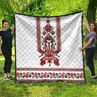 White quilt with centered red and black trident crest, folk border and roses