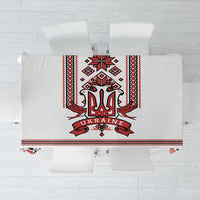 White tablecloth with red and black trident folk border and floral pattern in center