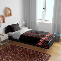 Black duvet cover and red geometric hem border on bed, with matching pillowcases and shams