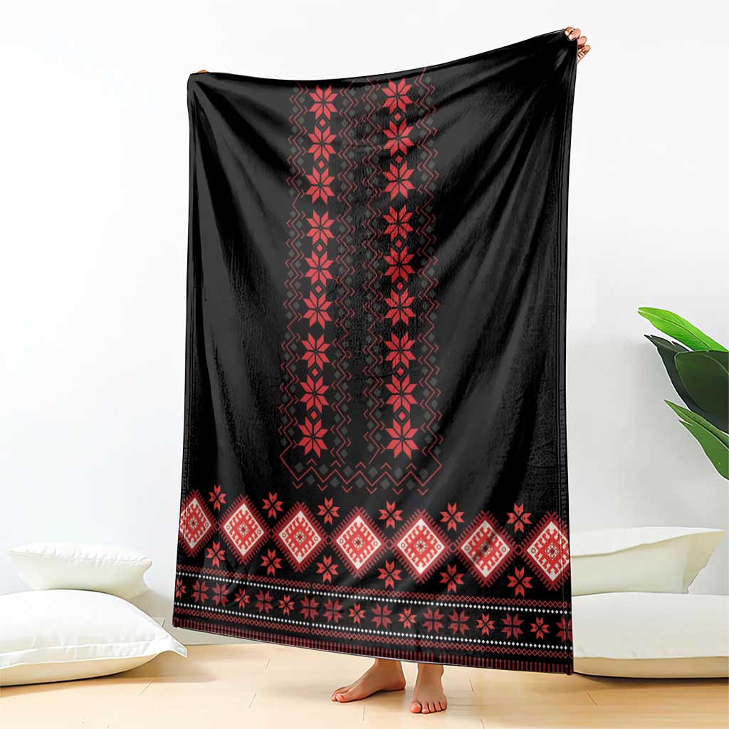 Folk pattern blanket: black with red vertical motifs and diamond border, hanging