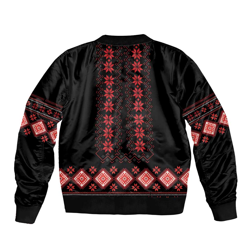 Black bomber jacket with red folk pattern across back and ribbed hem