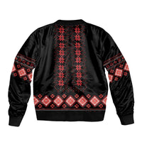 Black bomber jacket with red folk pattern across back and ribbed hem