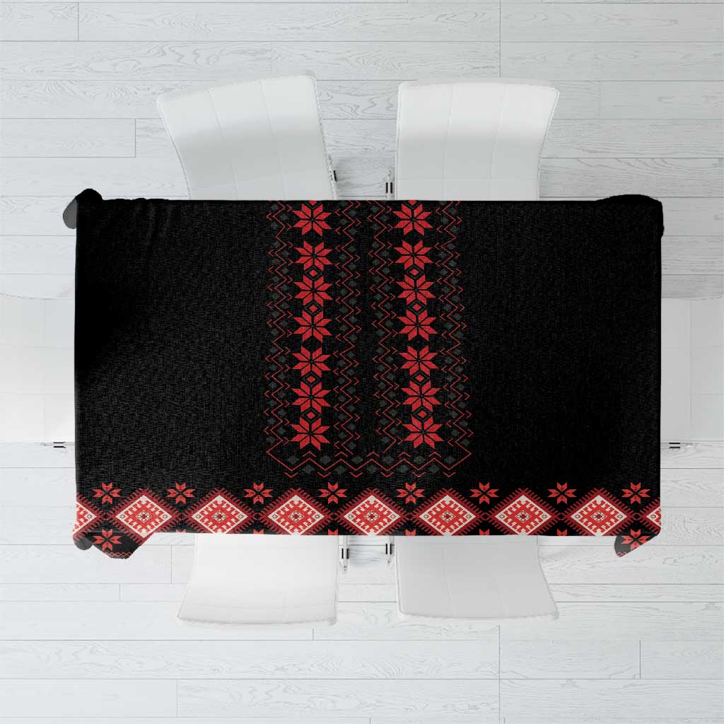 Black tablecloth with red geometric folk patterns and diamond border