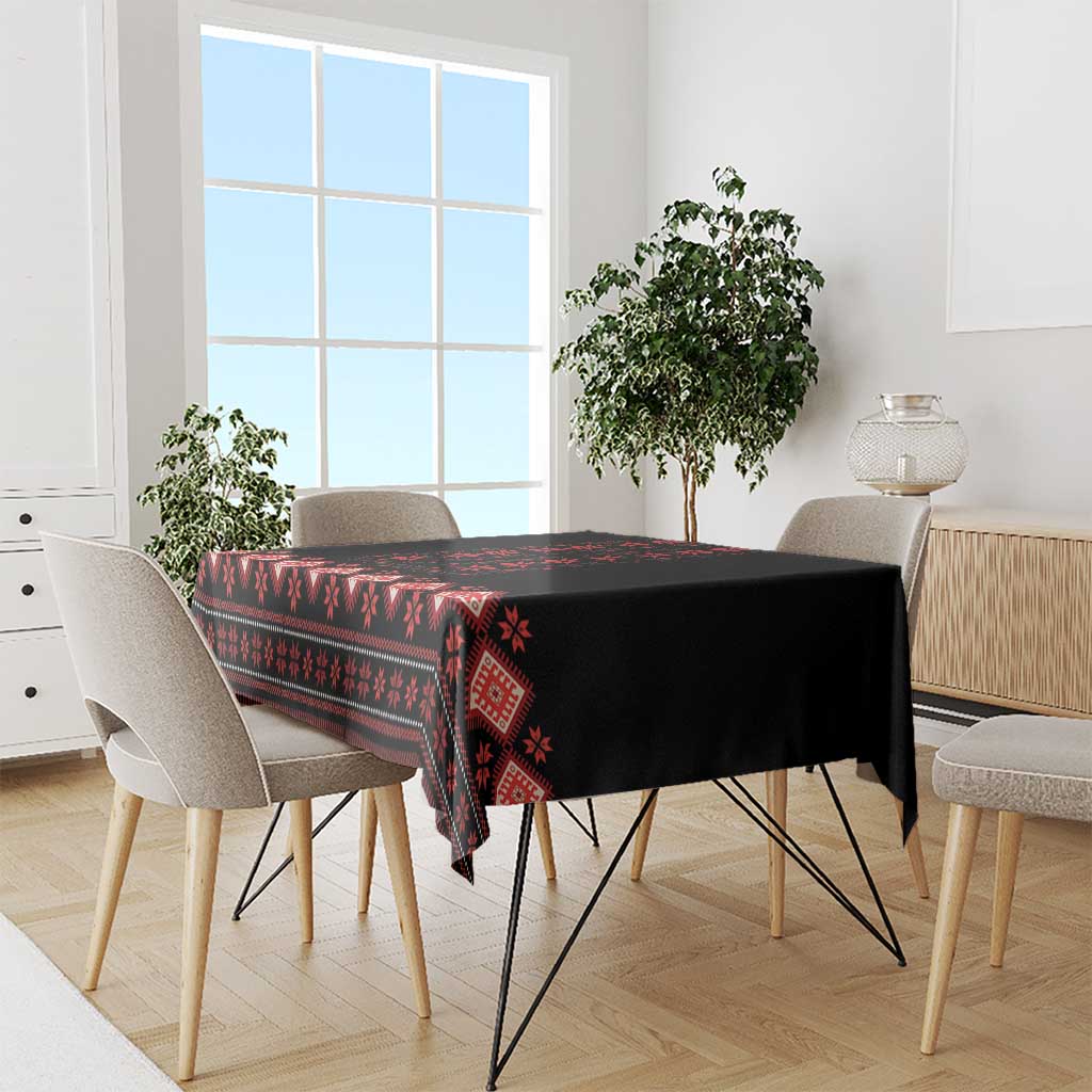 Black and red folk-pattern tablecloth draped over dining table