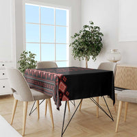 Black and red folk-pattern tablecloth draped over dining table