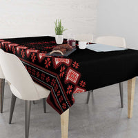 Black tablecloth with red folk stripes and motifs along the table edge