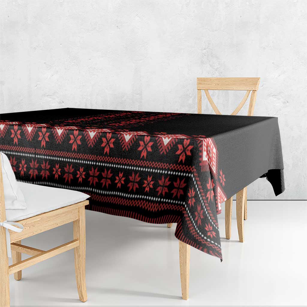Black and red folk-pattern tablecloth with scalloped drape on table
