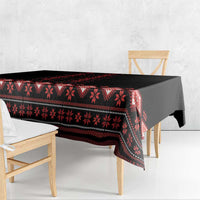 Black and red folk-pattern tablecloth with scalloped drape on table
