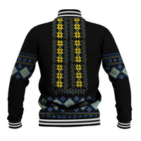 Black baseball jacket with yellow and blue folk pattern on back, striped cuffs and hem