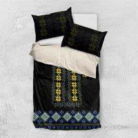 Black bedding set with yellow and blue folk embroidery panel; two dark pillow shams included