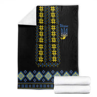 Folded Ukraine folk pattern blanket, black with blue and yellow geometric center and trident