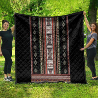 Black quilt laid out with vertical stripe panel and red, white, yellow geometric motifs