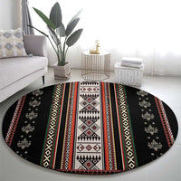 Round black folk-pattern carpet with wide central geometric panel and banded stripes